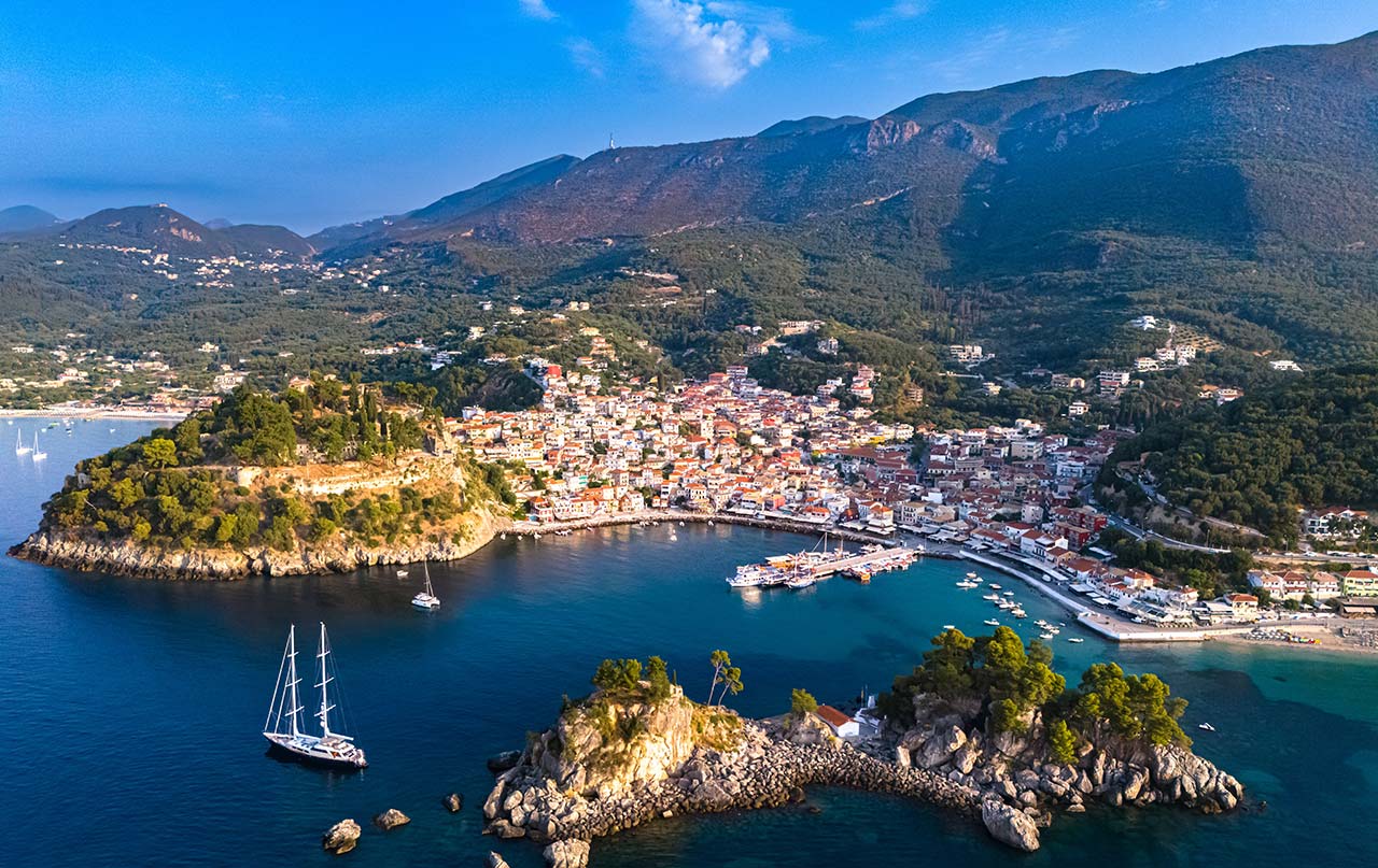 Aerial view of a coastal town in Greece with islands and blue sea