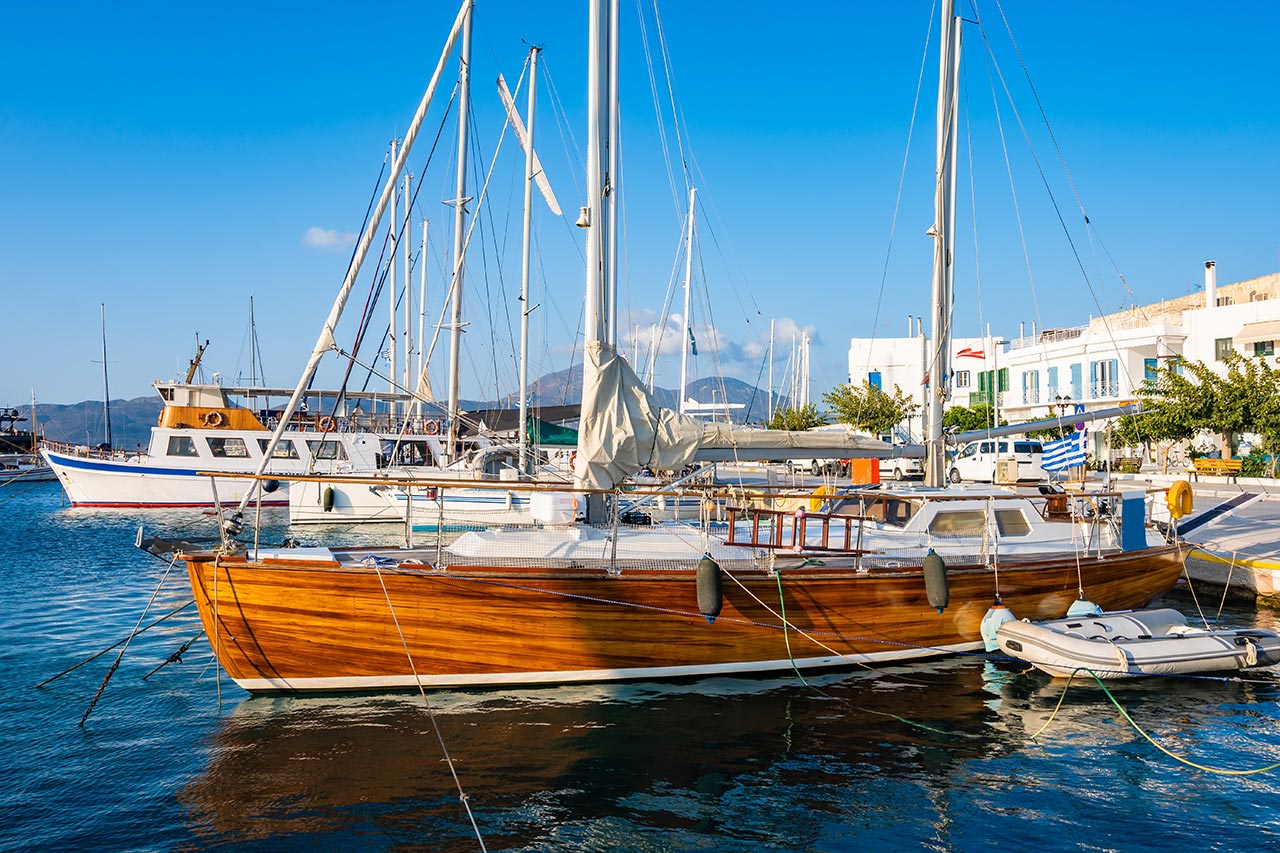 Traditional wooden sailing boat in Adamas port Milos