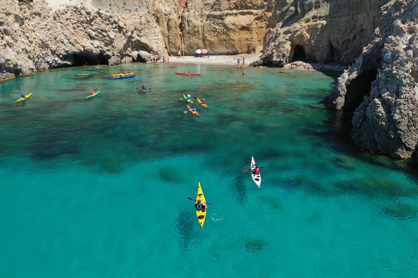 Outdoor activities in Milos kayaking at Tsigrado Beach