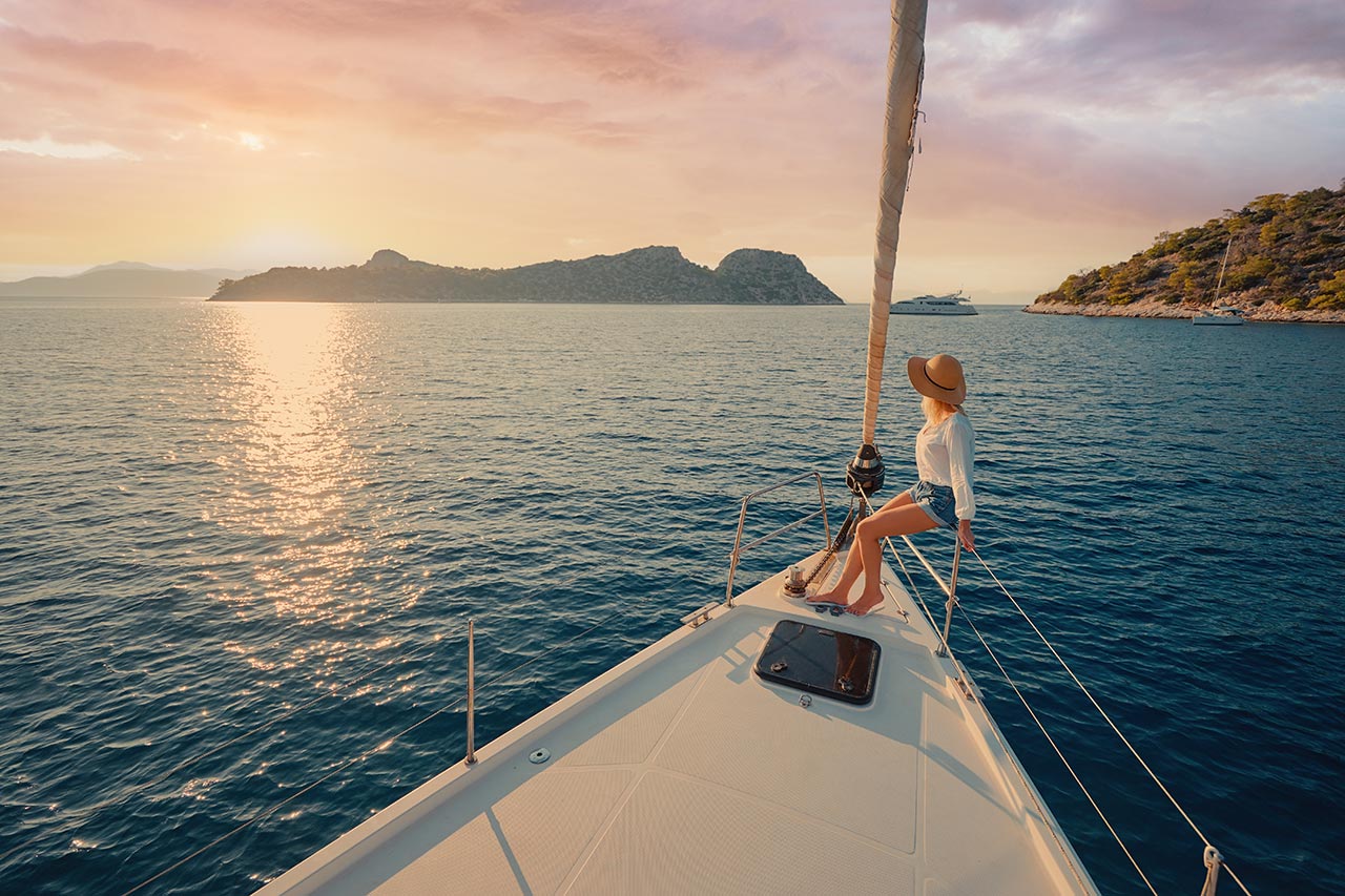 Woman enjoying sunset on a private Milos boat tour