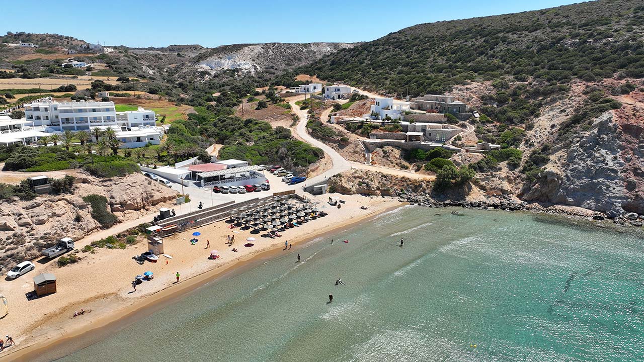 Aerial view of Provatas Beach in Milos with sandy shore and organized sunbeds